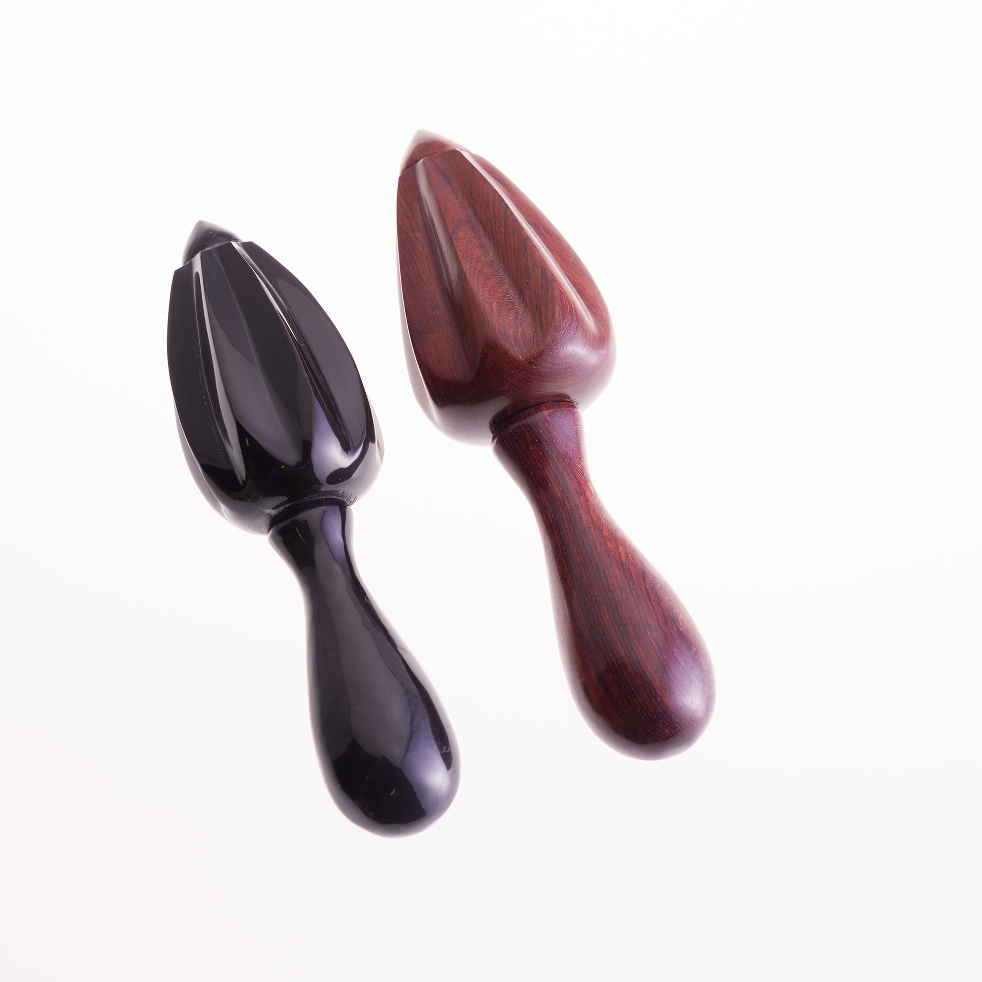 A pair of citrus reamers.  One made from black water buffalo horn, the other is made from rosewood.