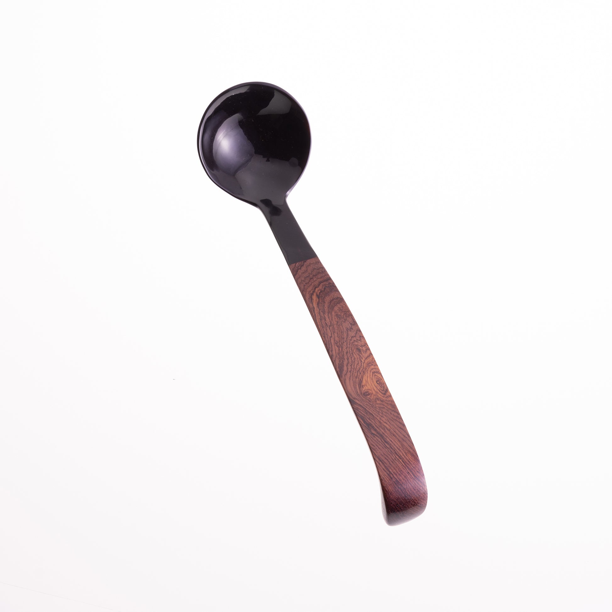 A large ladle made from water buffalo horn with a rosewood handle