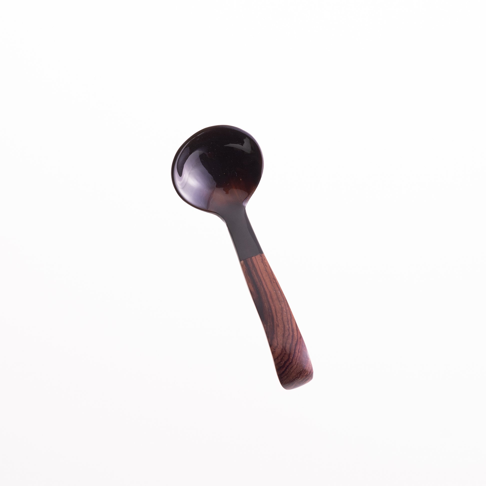 A small ladle made from water buffalo horn with a rosewood handle