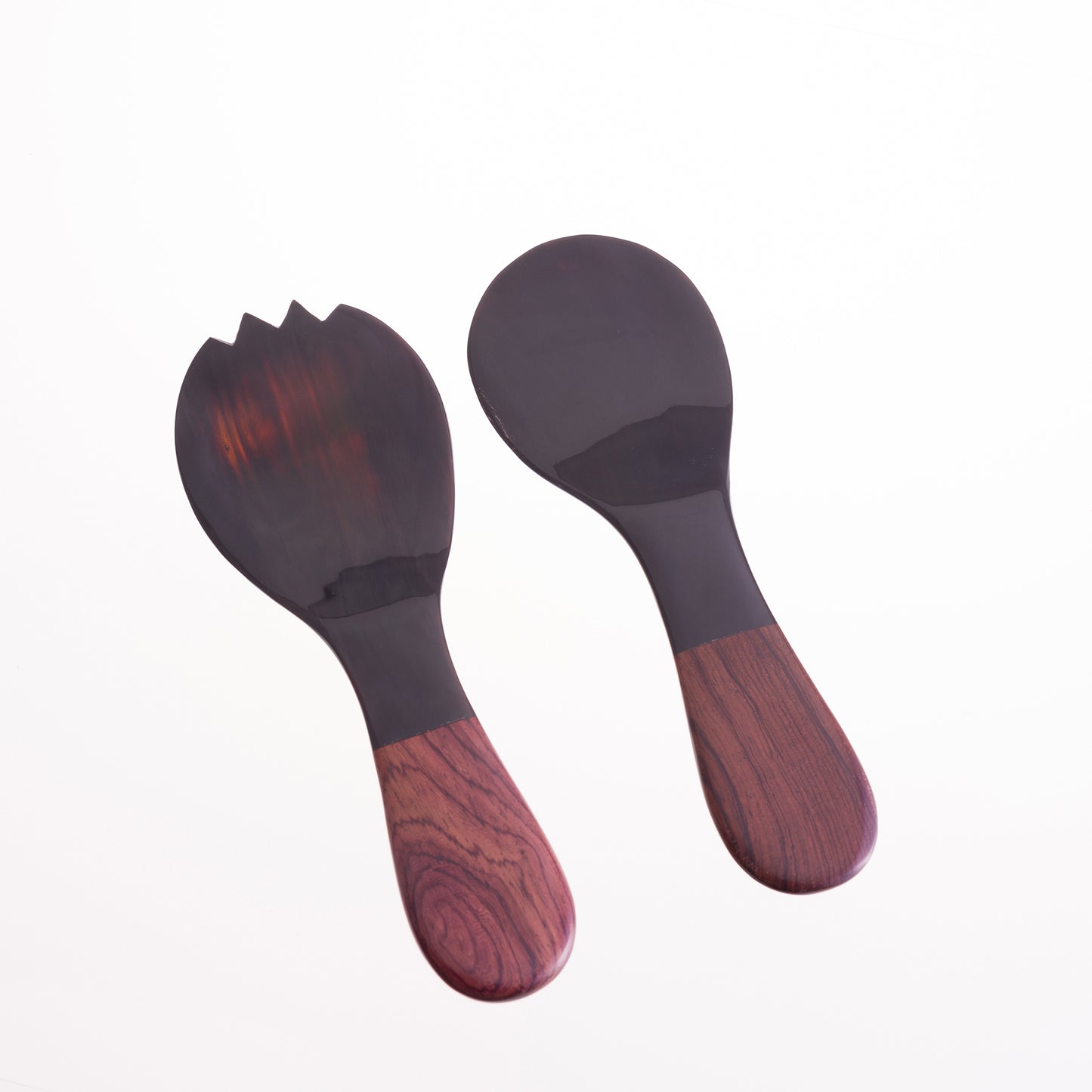 A pair of short salad servers made from water buffalo horn with rosewood handles