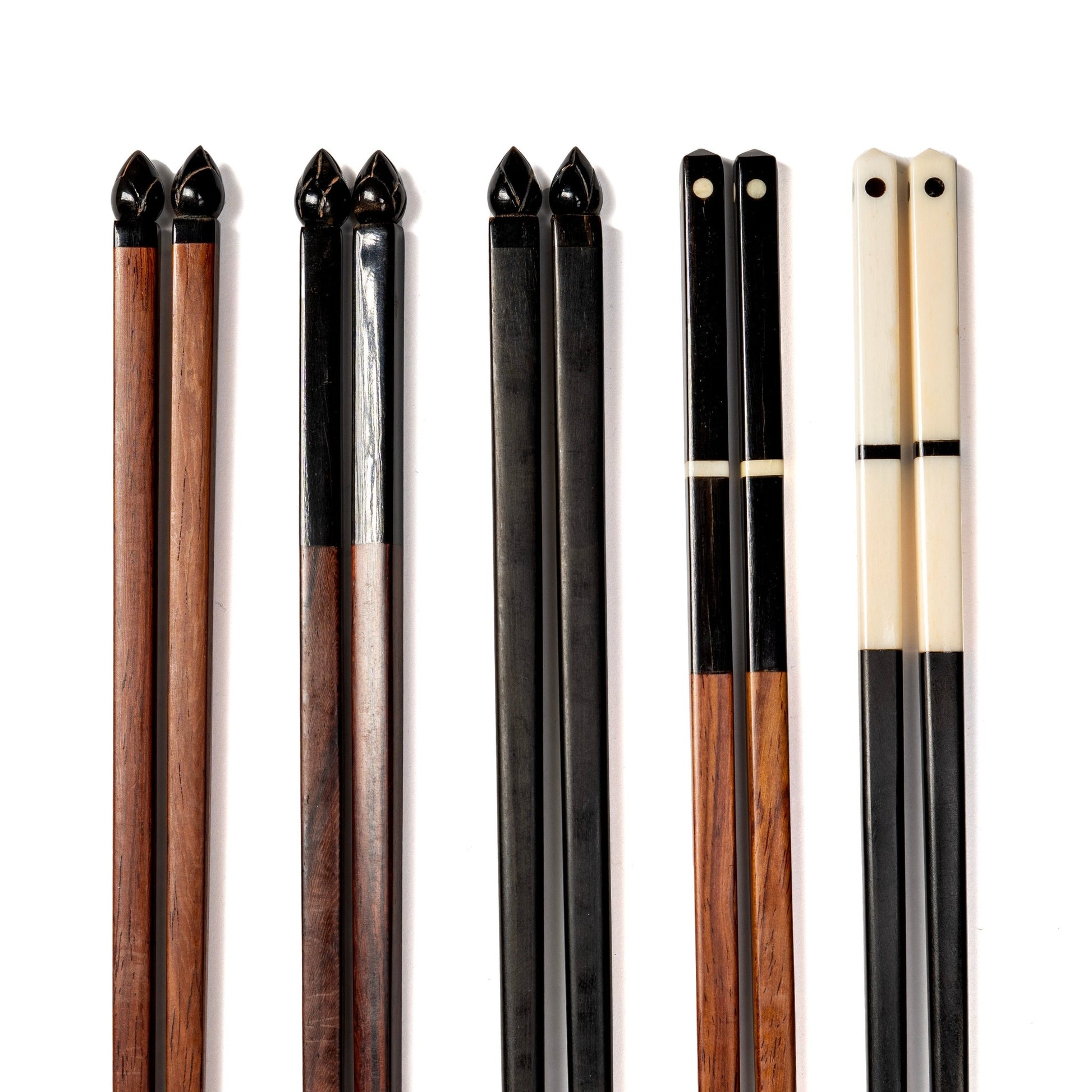 A row of 5 pairs of chopsticks made from rosewood and water buffalo horn, each with a different tip.