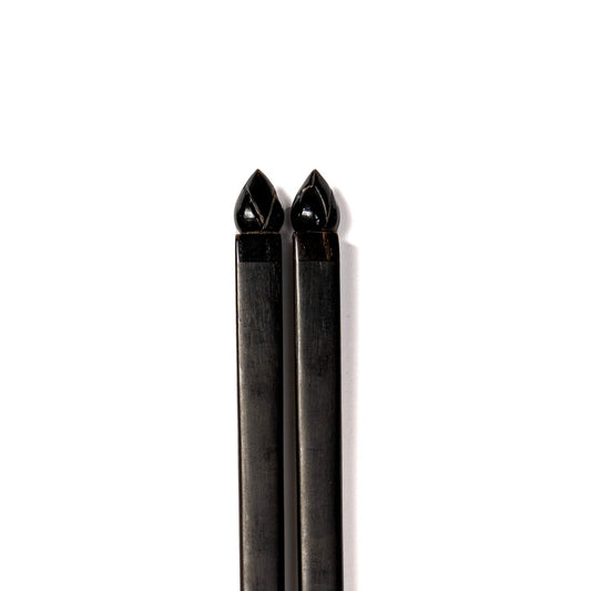 A pair of jet black chopsticks with Artichoke details