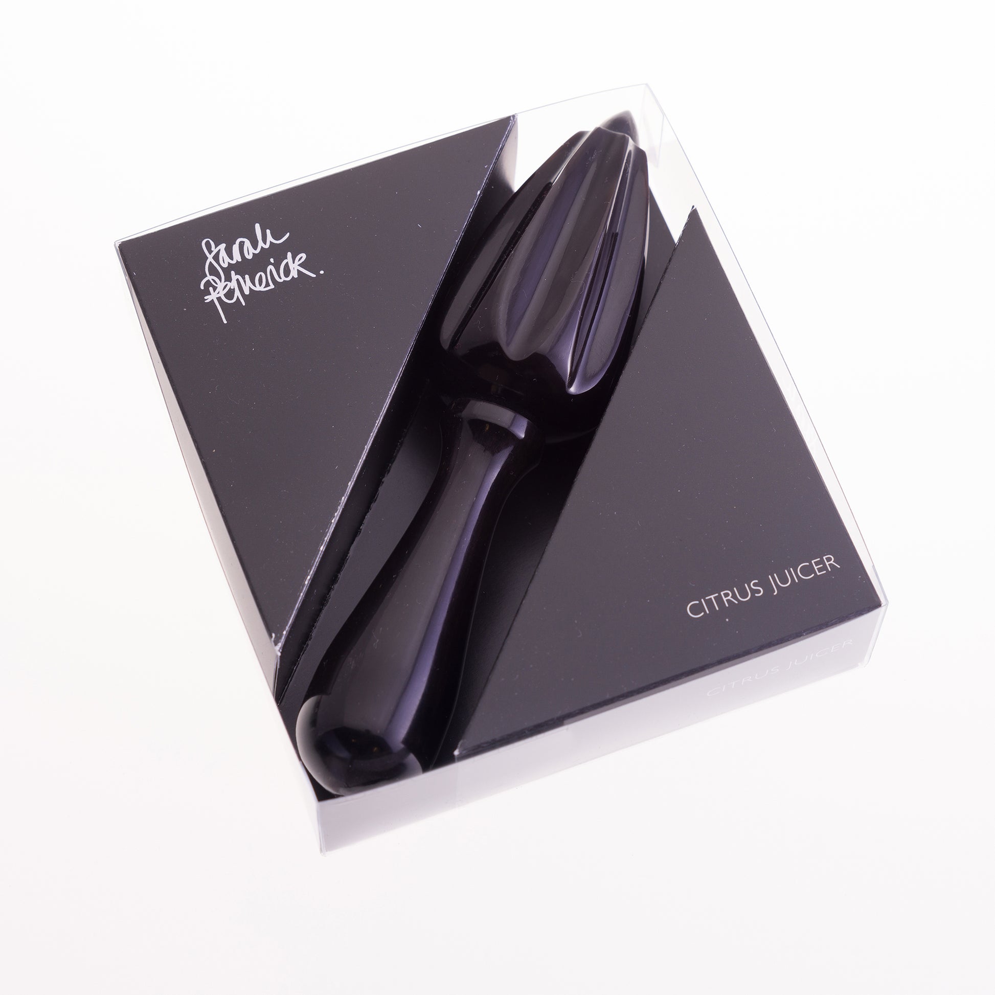 A black water buffalo horn citrus juicer  packaged in a clear box with black card insert